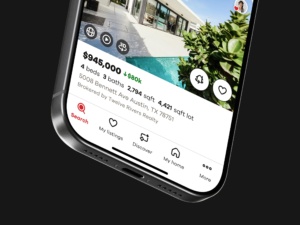 Realtor.com iOS property listing interface featuring the FlyAround 3D exploration action alongside property details, photos, and saved-listing controls.