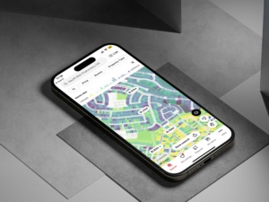Realtor.com mobile map showing a TopHap-powered home size layer with color-coded parcel data, property prices, and search controls.